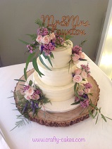 3 tier buttercream wedding cake with fresh flowers